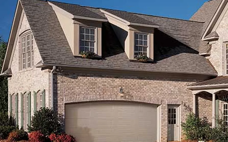 Amarr Lincoln almond garage door on a brick home
